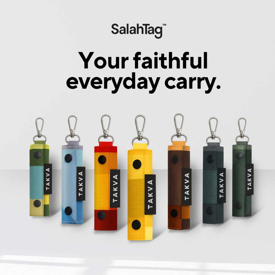 Seven SalahTag portable prayer mats in different colors with carabiner clips displayed in a row